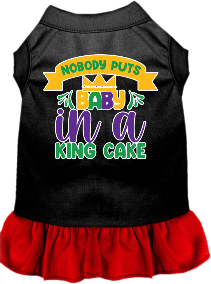 A cute screen printed dress for small to medium pets, featuring ruffles and the phrase 'Nobody Puts Baby In A King Cake'.