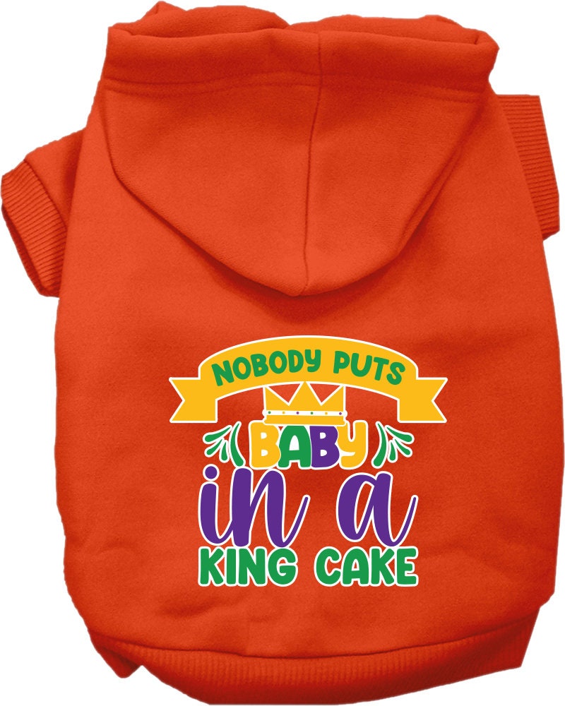 A medium to large pet wearing a soft, warm hoodie with the phrase 'Nobody Puts Baby In A King Cake' printed on it, showcasing its stylish design.