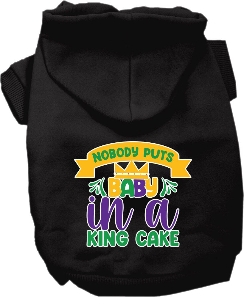 A medium to large pet wearing a soft, warm hoodie with the phrase 'Nobody Puts Baby In A King Cake' printed on it, showcasing its stylish design.