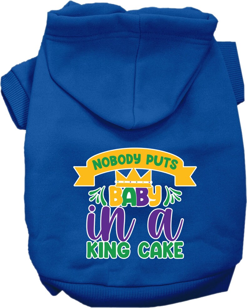 A medium to large pet wearing a soft, warm hoodie with the phrase 'Nobody Puts Baby In A King Cake' printed on it, showcasing its stylish design.