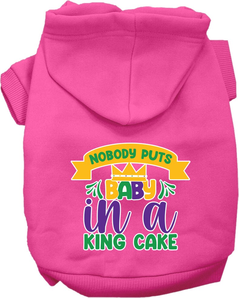 A medium to large pet wearing a soft, warm hoodie with the phrase 'Nobody Puts Baby In A King Cake' printed on it, showcasing its stylish design.