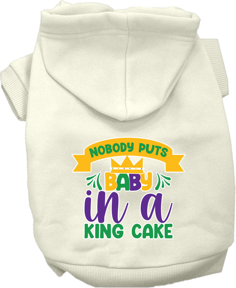A medium to large pet wearing a soft, warm hoodie with the phrase 'Nobody Puts Baby In A King Cake' printed on it, showcasing its stylish design.