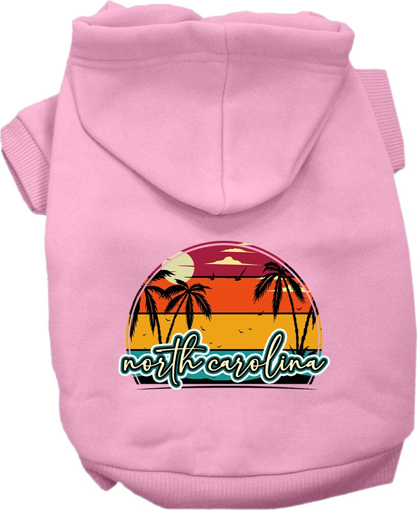 A medium to large pet wearing a soft and stylish screen printed hoodie featuring a North Carolina retro beach sunset design.