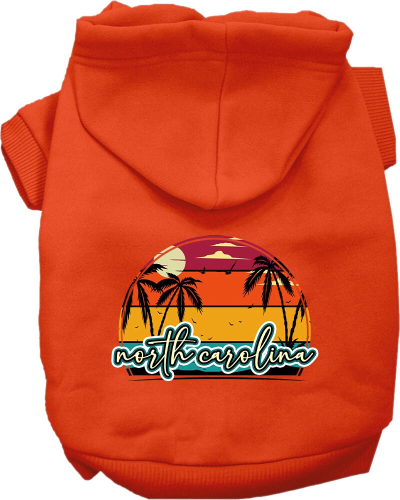 A medium to large pet wearing a soft and stylish screen printed hoodie featuring a North Carolina retro beach sunset design.