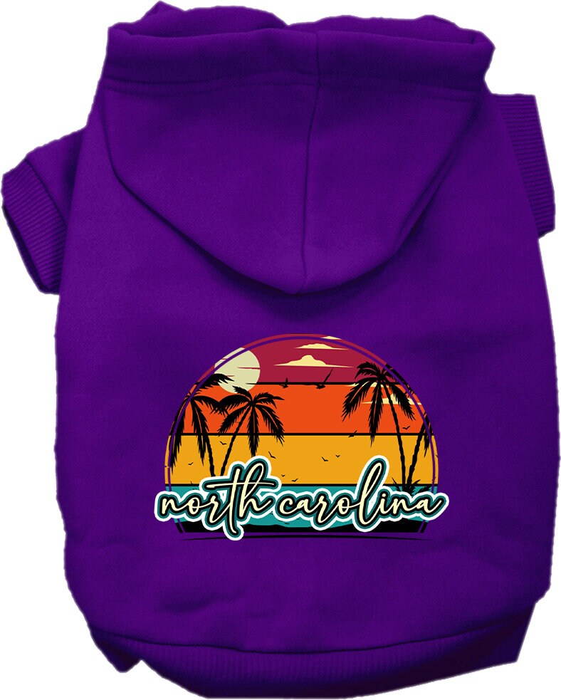 A medium to large pet wearing a soft and stylish screen printed hoodie featuring a North Carolina retro beach sunset design.
