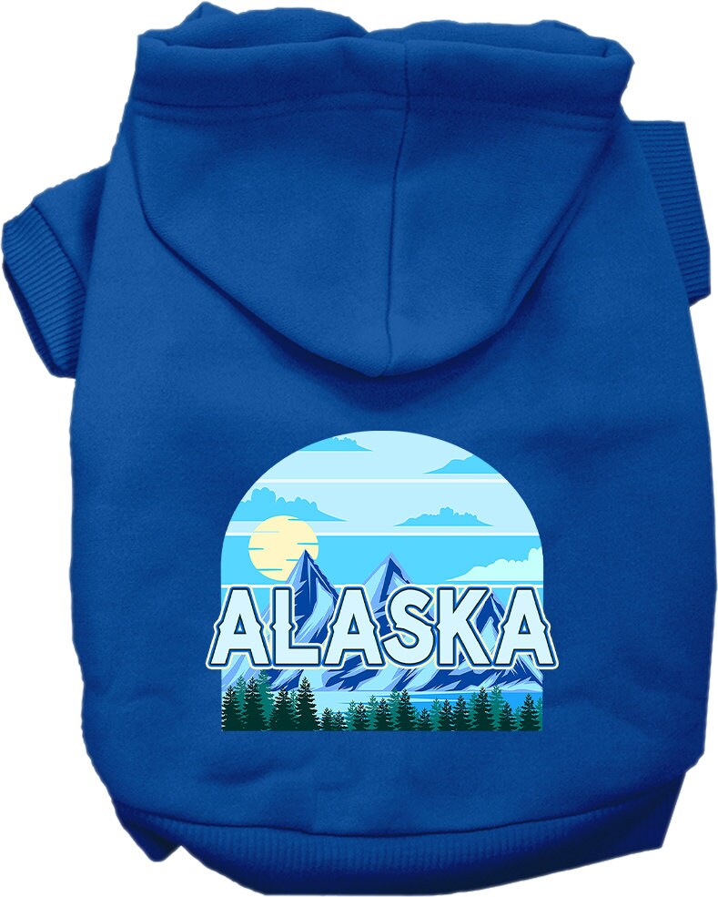 A small to medium pet wearing a cozy Alaska Trailblazer hoodie, showcasing its stylish design and convenient leash access hole.