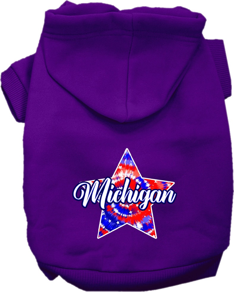 A small to medium pet wearing a Michigan Patriotic Tie Dye hoodie, showcasing its vibrant colors and comfortable fit.