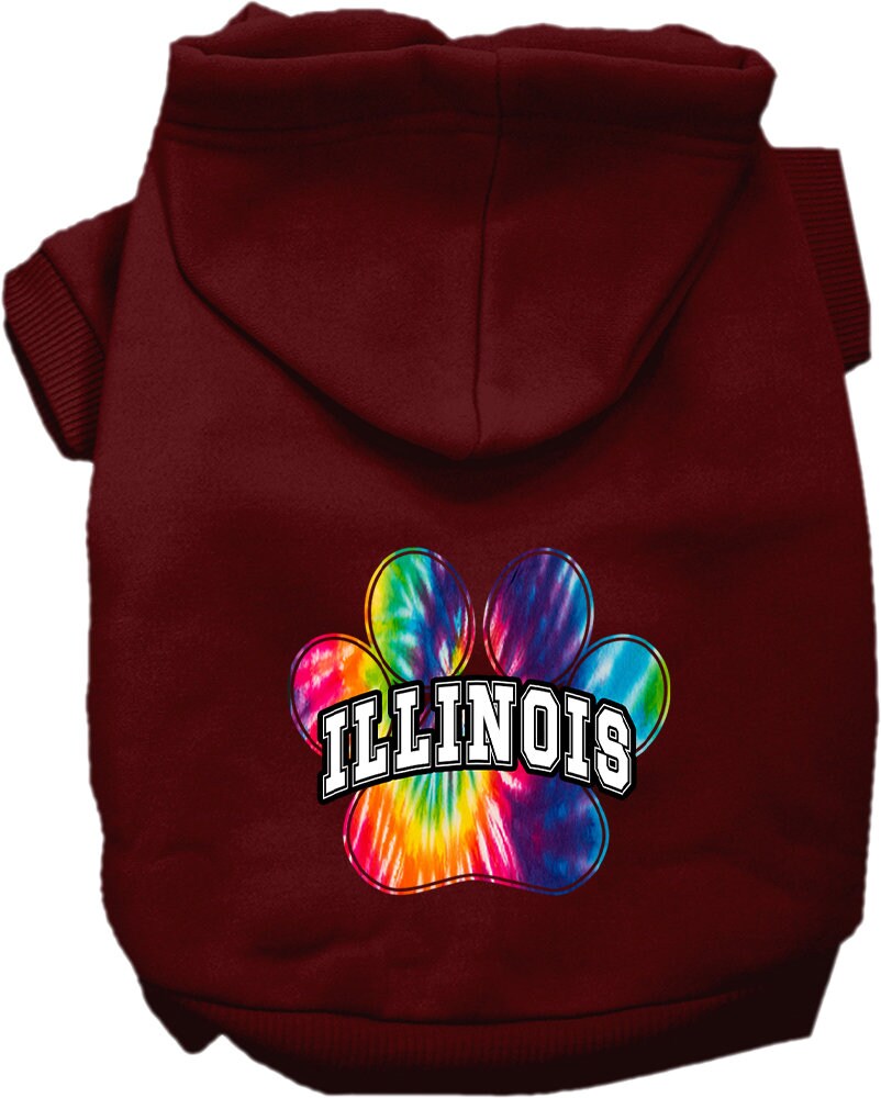 A small to medium pet wearing a colorful Illinois Bright Tie Dye hoodie, showcasing its soft fabric and convenient leash access hole.