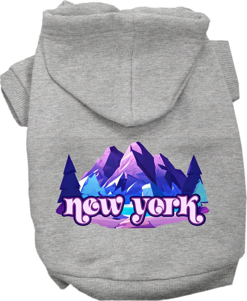 A small to medium pet wearing a stylish screen printed hoodie with a 'New York Alpine Pawscape' design, showcasing comfort and durability.