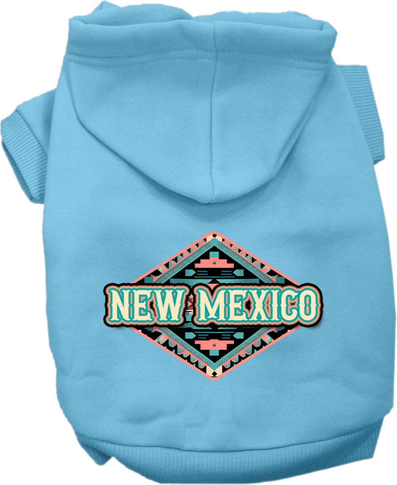 A small to medium pet wearing a soft, warm hoodie with a New Mexico Peach Aztec design, showcasing its stylish and durable features.