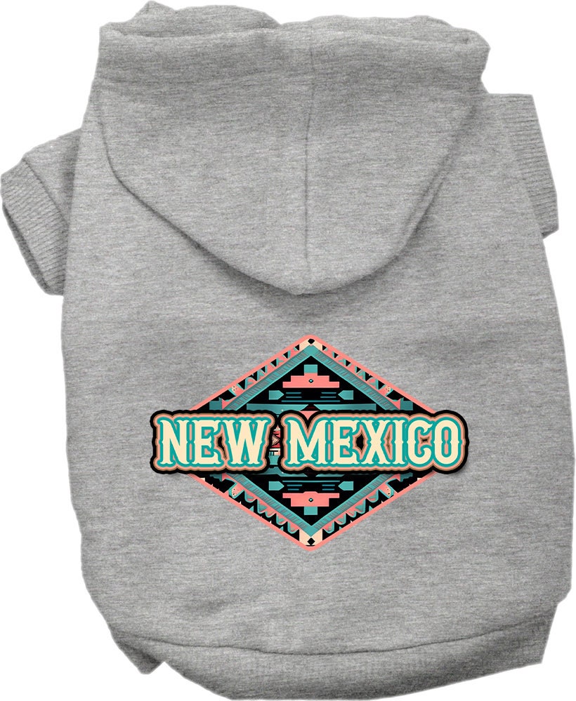 A small to medium pet wearing a soft, warm hoodie with a New Mexico Peach Aztec design, showcasing its stylish and durable features.