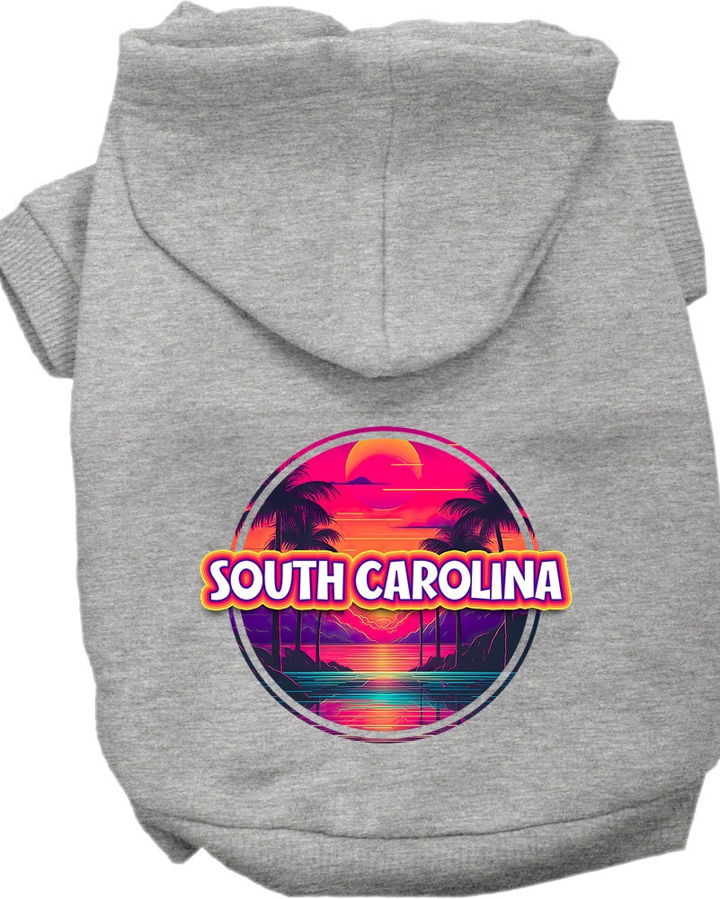 A small to medium pet wearing a vibrant South Carolina Neon Beach Sunset hoodie, showcasing its soft fabric and convenient leash access hole.