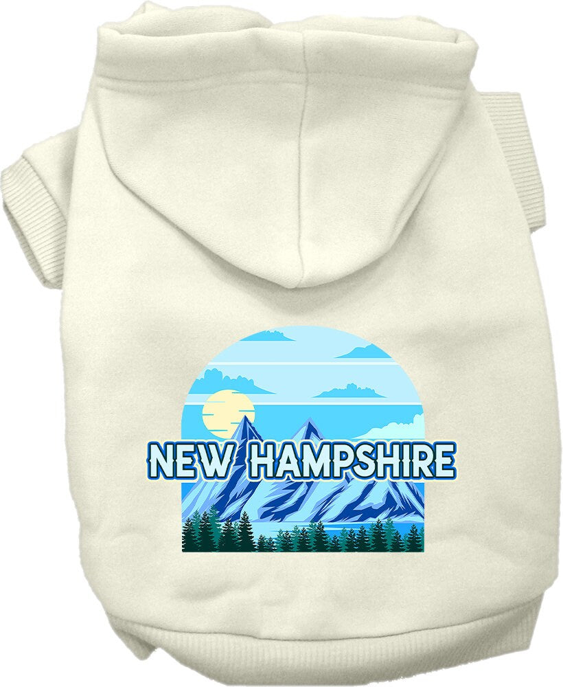 A small to medium pet wearing a stylish screen printed hoodie with a New Hampshire Trailblazer design, showcasing its soft fabric and convenient leash access.