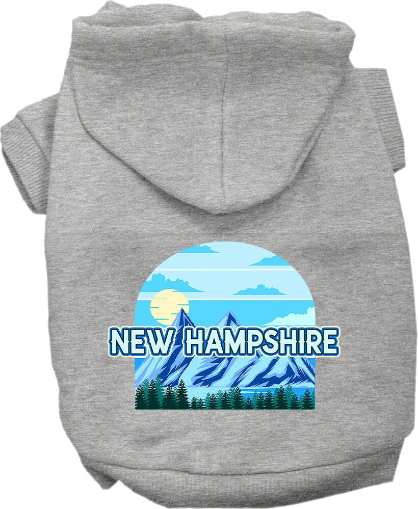 A small to medium pet wearing a stylish screen printed hoodie with a New Hampshire Trailblazer design, showcasing its soft fabric and convenient leash access.