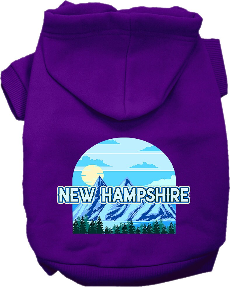 A small to medium pet wearing a stylish screen printed hoodie with a New Hampshire Trailblazer design, showcasing its soft fabric and convenient leash access.