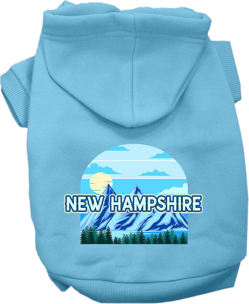 A small to medium pet wearing a stylish screen printed hoodie with a New Hampshire Trailblazer design, showcasing its soft fabric and convenient leash access.