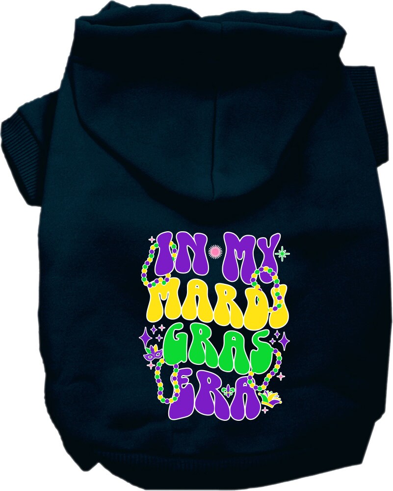 A small to medium pet wearing a colorful screen printed hoodie with the text 'In My Mardi Gras Era', showcasing a festive design.