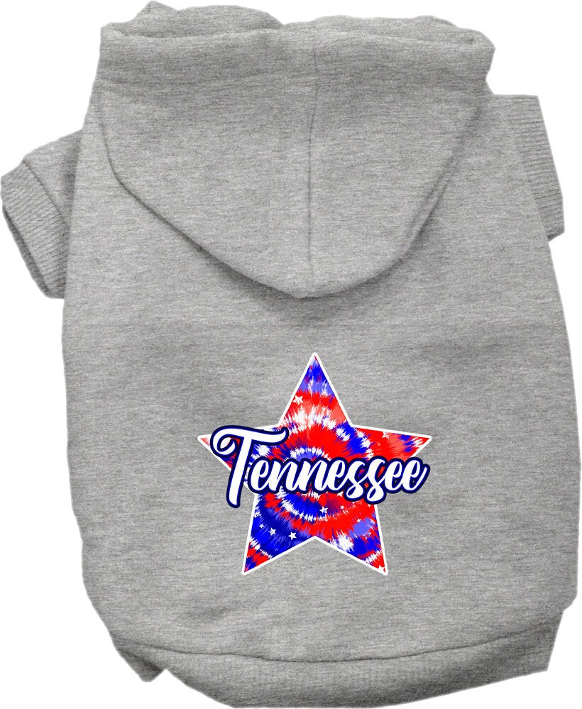 A small to medium pet wearing a Tennessee Patriotic Tie Dye hoodie, showcasing its vibrant colors and comfortable fit.