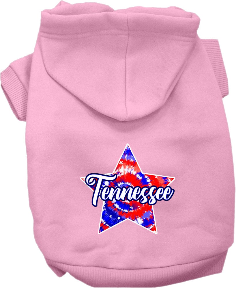 A small to medium pet wearing a Tennessee Patriotic Tie Dye hoodie, showcasing its vibrant colors and comfortable fit.