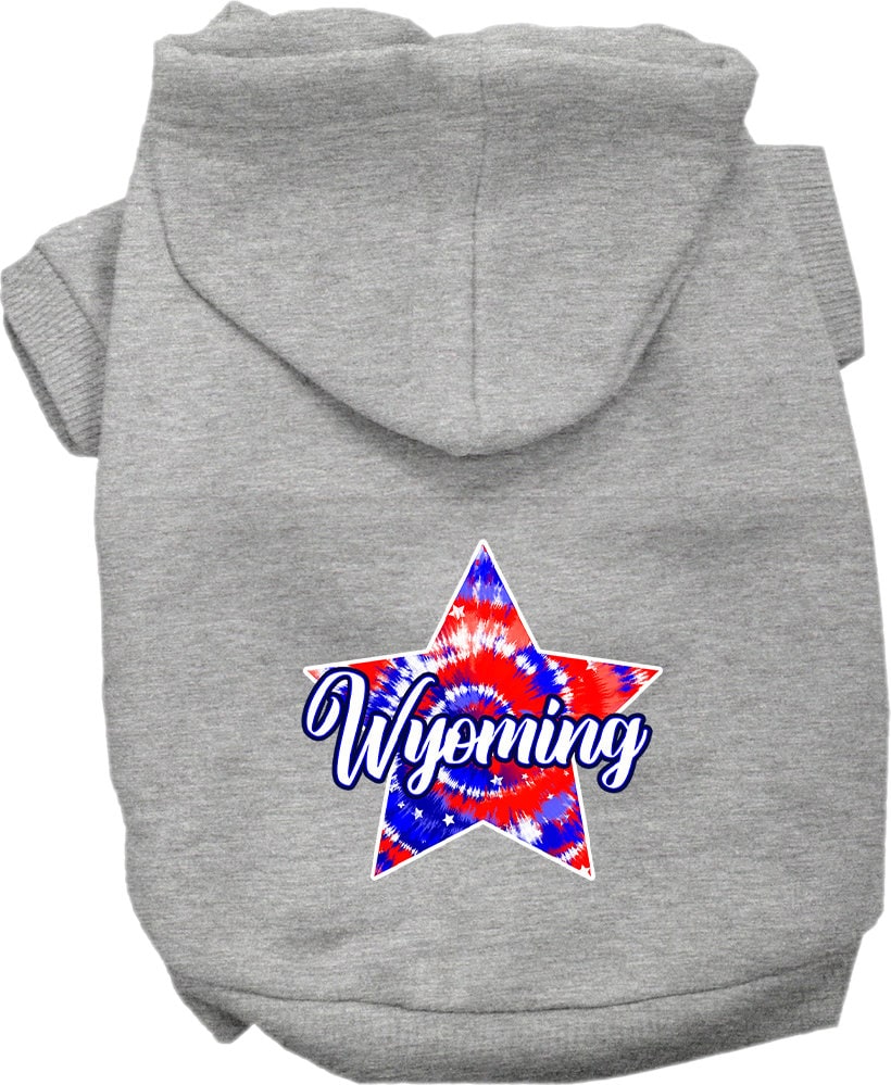 A small to medium pet wearing a Wyoming Patriotic Tie Dye hoodie, showcasing its vibrant colors and comfortable fit.