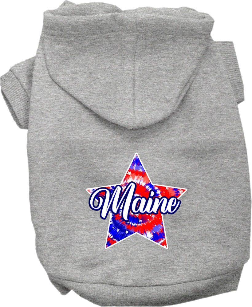 A small to medium pet wearing a Maine Patriotic Tie Dye hoodie, showcasing its vibrant colors and comfortable fit.
