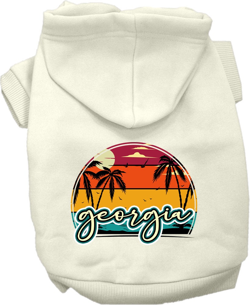 A small to medium pet wearing a stylish Georgia Retro Beach Sunset hoodie, showcasing its vibrant colors and comfortable fit.