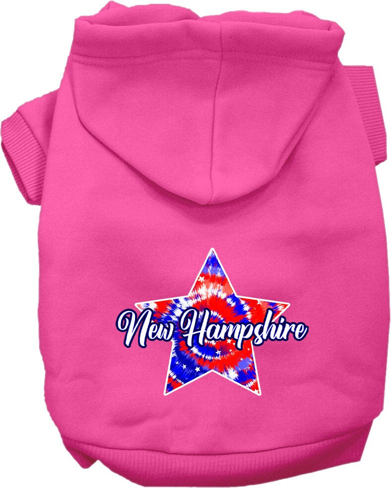 A small to medium pet wearing a New Hampshire Patriotic Tie Dye hoodie, showcasing its vibrant colors and comfortable fit.