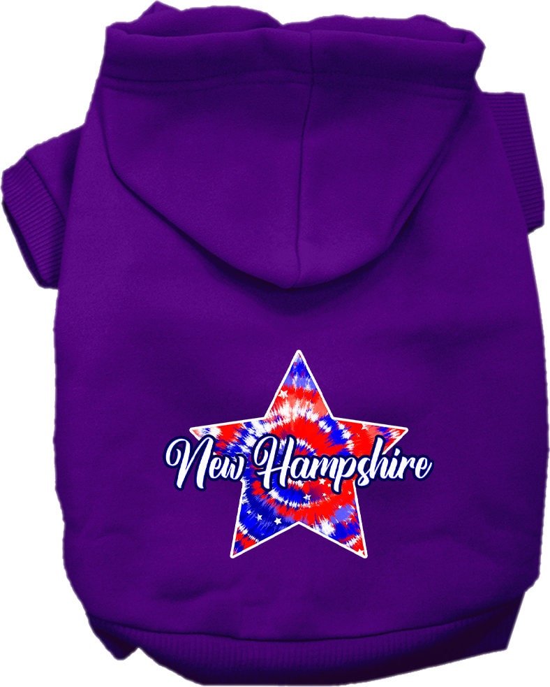 A small to medium pet wearing a New Hampshire Patriotic Tie Dye hoodie, showcasing its vibrant colors and comfortable fit.