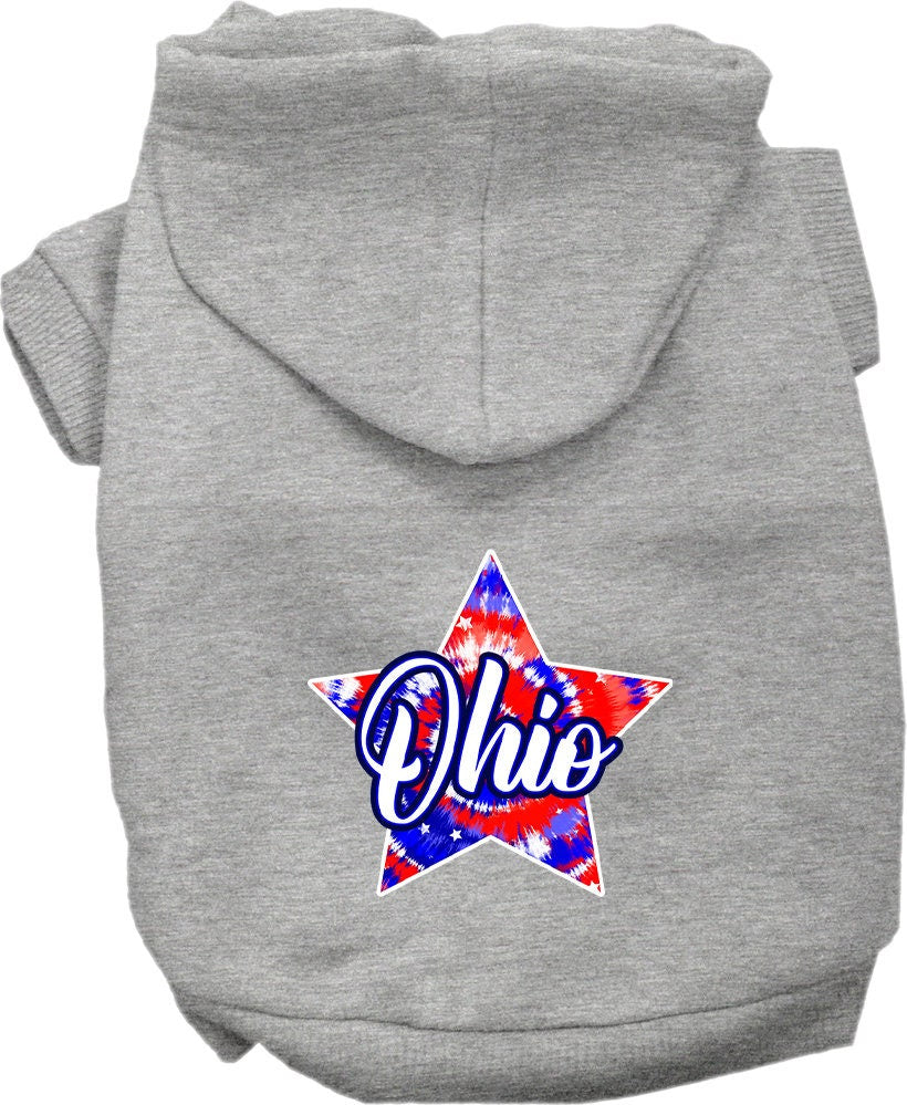 A small to medium pet wearing a vibrant Ohio Patriotic Tie Dye hoodie, showcasing its soft fabric and convenient leash access hole.