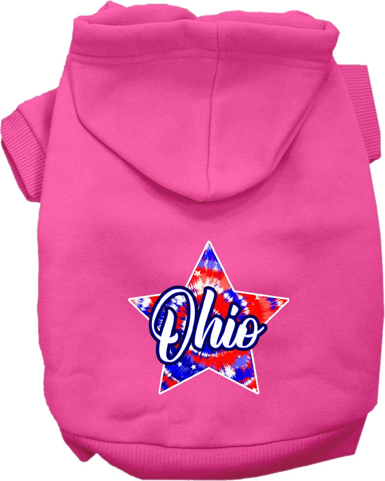 A small to medium pet wearing a vibrant Ohio Patriotic Tie Dye hoodie, showcasing its soft fabric and convenient leash access hole.