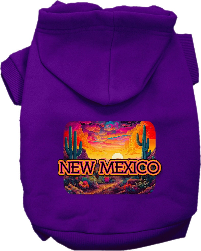 A small to medium pet wearing a vibrant New Mexico Neon Desert printed hoodie, showcasing its soft fabric and convenient leash access hole.