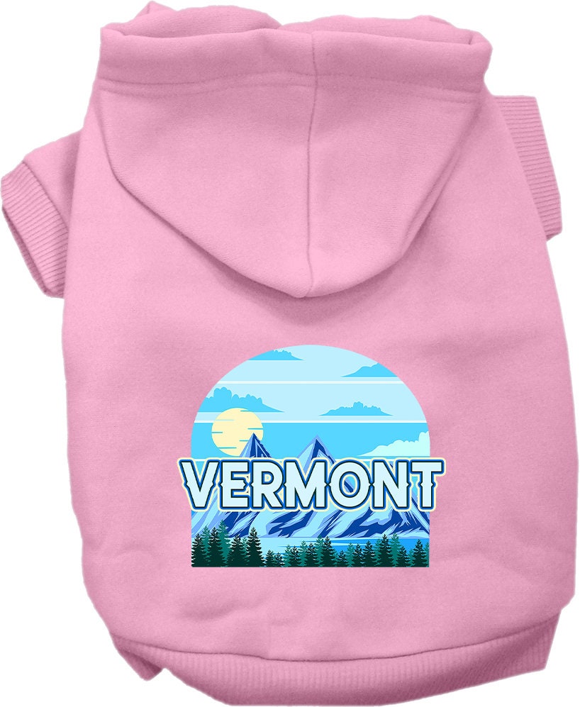 A small to medium pet wearing a cozy screen printed hoodie with a Vermont Trailblazer design, showcasing its soft fabric and convenient leash access hole.