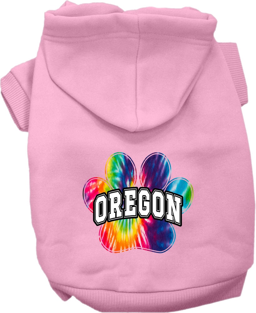 A small to medium pet wearing a vibrant Oregon Bright Tie Dye hoodie, showcasing its soft fabric and convenient leash access hole.