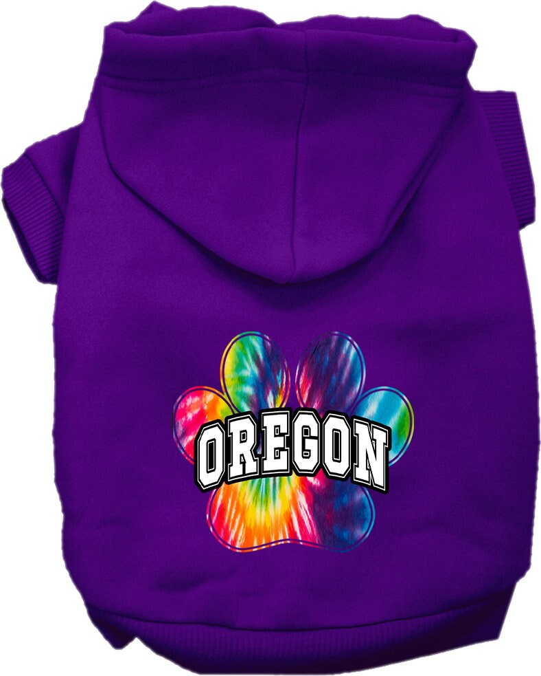 A small to medium pet wearing a vibrant Oregon Bright Tie Dye hoodie, showcasing its soft fabric and convenient leash access hole.