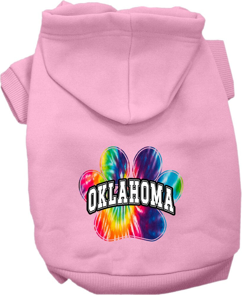 A small to medium pet wearing a vibrant Oklahoma Bright Tie Dye hoodie, showcasing its soft fabric and convenient leash access hole.