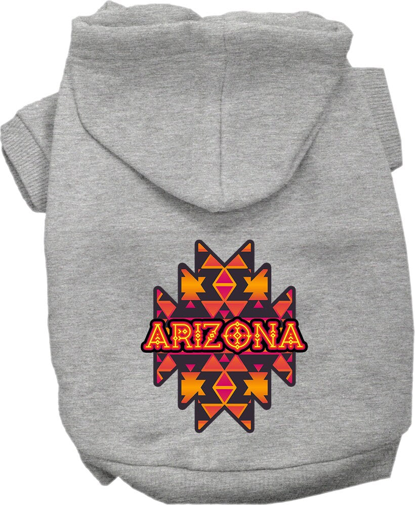 A small to medium pet wearing a cozy Arizona Navajo Tribal screen printed hoodie, showcasing its unique design and comfortable fit.