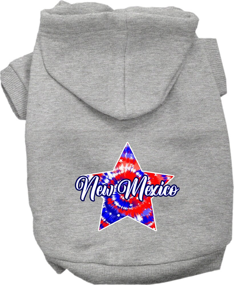A small to medium pet wearing a New Mexico Patriotic Tie Dye hoodie, showcasing its vibrant colors and comfortable fit.