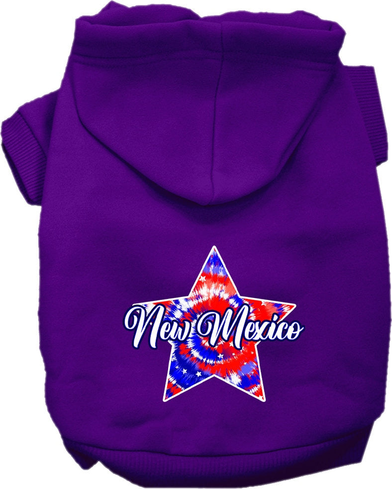 A small to medium pet wearing a New Mexico Patriotic Tie Dye hoodie, showcasing its vibrant colors and comfortable fit.