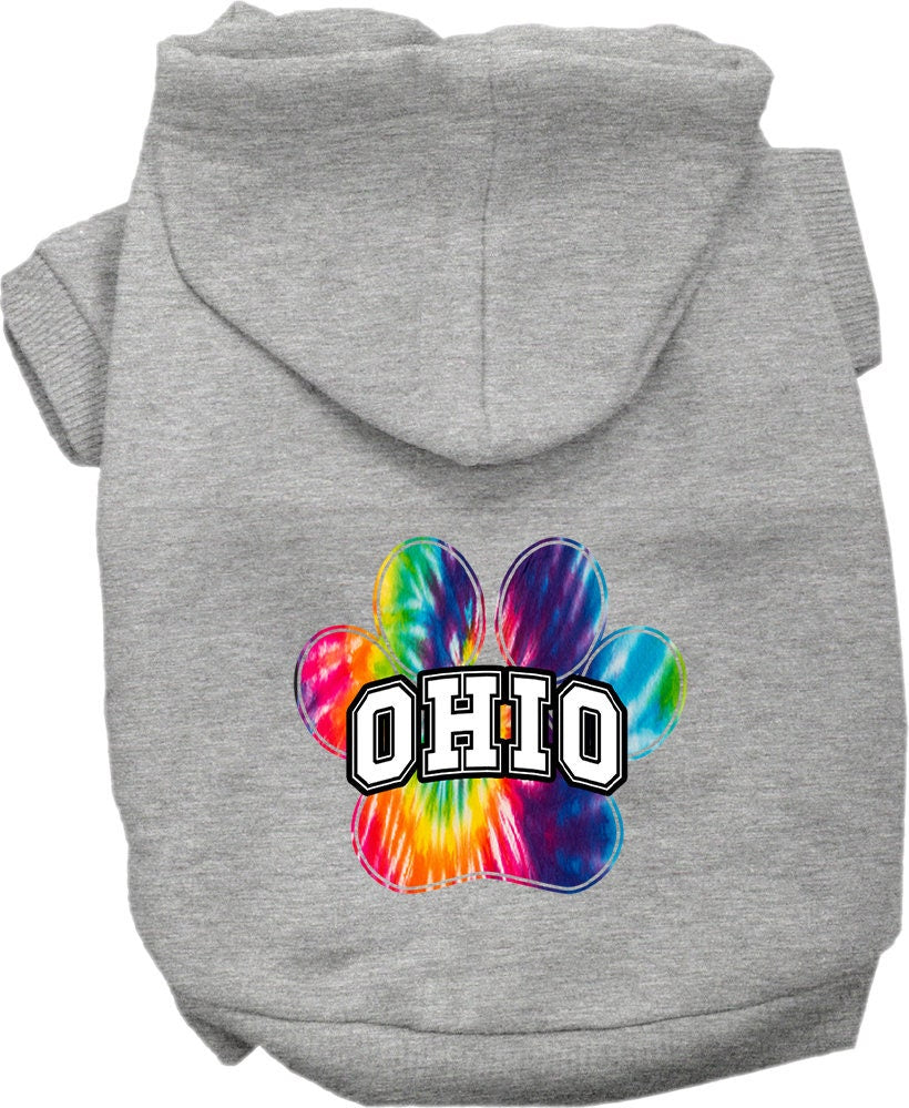 A small to medium pet wearing a vibrant Ohio Bright Tie Dye hoodie, showcasing its soft fabric and convenient leash access hole.