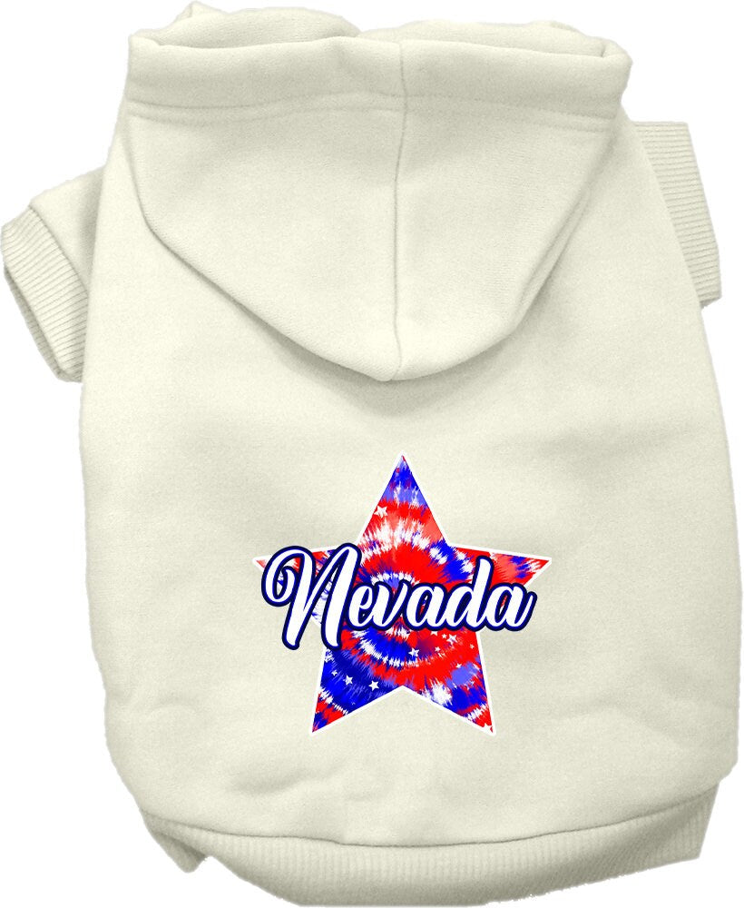 A small to medium pet wearing a colorful Nevada Patriotic Tie Dye hoodie, showcasing its soft fabric and convenient leash access hole.
