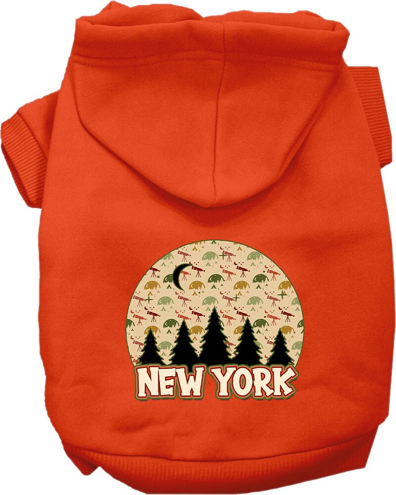 A small to medium pet wearing a stylish screen printed hoodie with a 'New York Under The Stars' design, showcasing its soft fabric and convenient leash access hole.