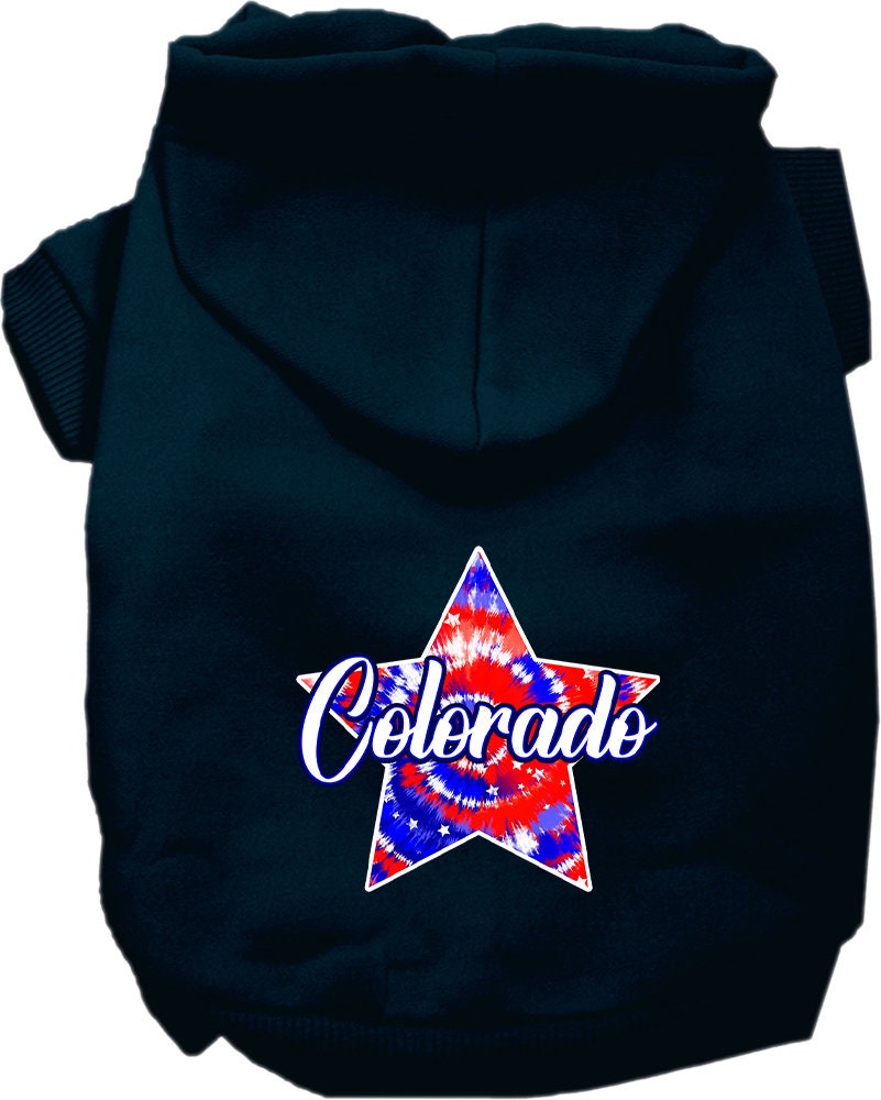 A small to medium pet wearing a colorful Colorado Patriotic Tie Dye hoodie, showcasing its soft fabric and convenient leash access hole.