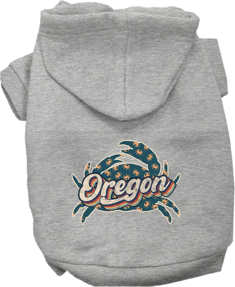 A small to medium pet wearing a cozy Oregon Retro Crabs screen printed hoodie, showcasing its vibrant design and comfortable fit.