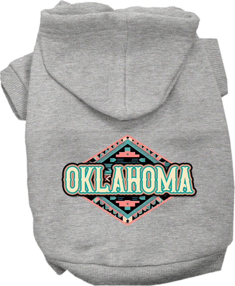 A small to medium pet wearing a cozy Oklahoma Peach Aztec hoodie, showcasing its vibrant colors and stylish design.