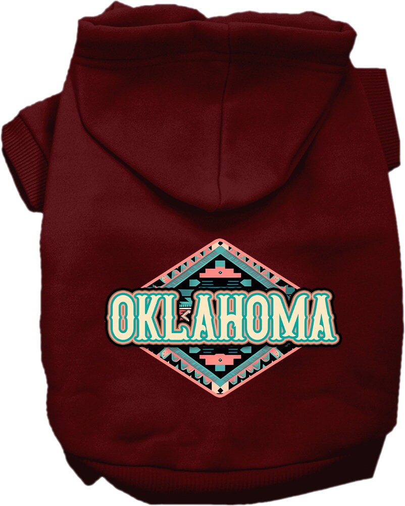 A small to medium pet wearing a cozy Oklahoma Peach Aztec hoodie, showcasing its vibrant colors and stylish design.
