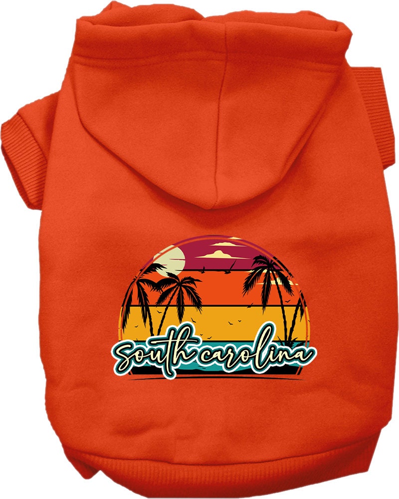 A small to medium pet wearing a soft, stylish hoodie featuring a South Carolina Retro Beach Sunset design, perfect for walks and outdoor activities.