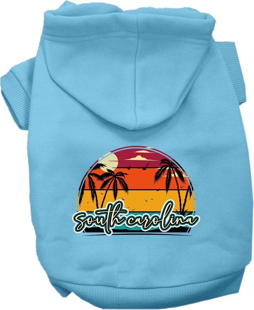 A small to medium pet wearing a soft, stylish hoodie featuring a South Carolina Retro Beach Sunset design, perfect for walks and outdoor activities.