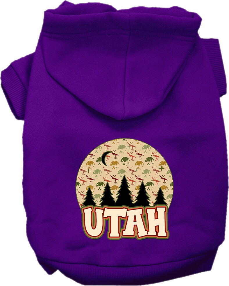 A small to medium pet wearing a cozy screen printed hoodie with a 'Utah Under The Stars' design, showcasing its soft fabric and convenient leash access.