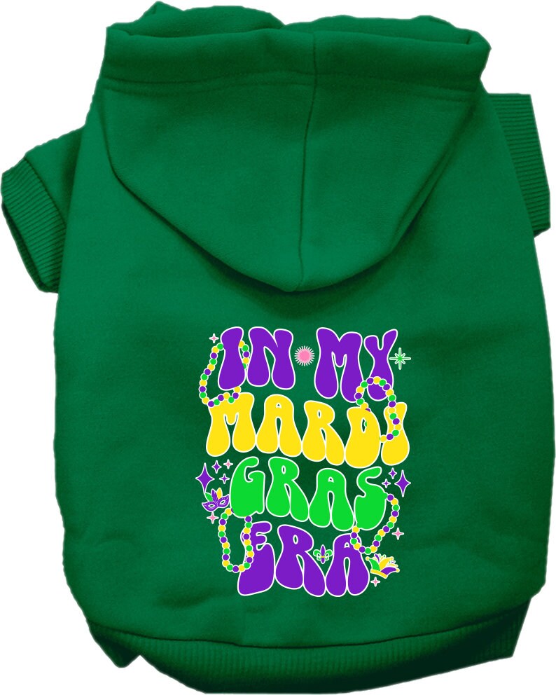 A small to medium pet wearing a colorful screen printed hoodie that says 'In My Mardi Gras Era', showcasing a festive design.