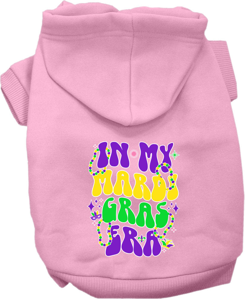 A small to medium pet wearing a colorful screen printed hoodie that says 'In My Mardi Gras Era', showcasing a festive design.